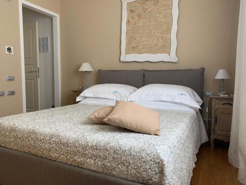 a bedroom with a bed with a pillow on it at White House Luxury Hospitality in Olbia