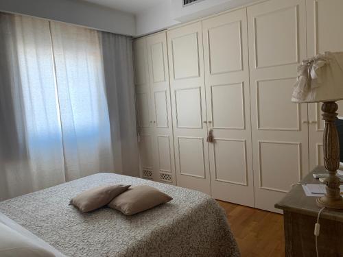 a bedroom with a bed with two pillows on it at White House Luxury Hospitality in Olbia