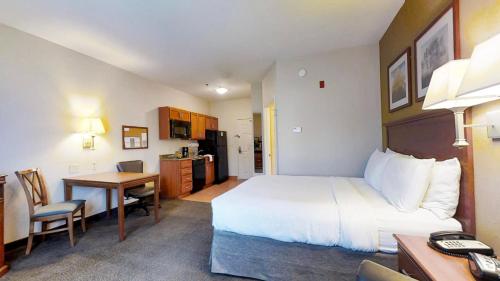 a hotel room with a large bed and a desk at Candlewood Suites Slidell Northshore, an IHG Hotel in Slidell