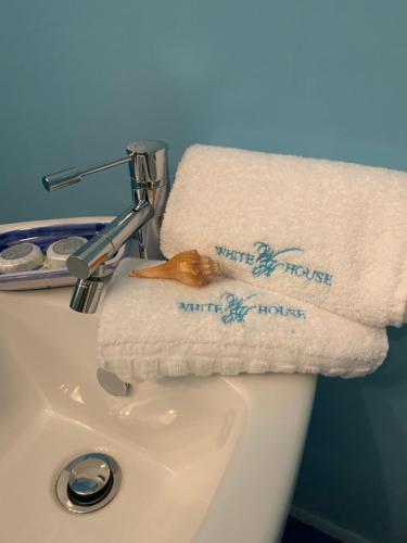 a white sink with towels on top of it at White House Luxury Hospitality in Olbia