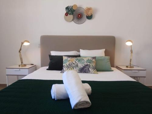 a bedroom with a large bed with two lamps at ALMA Flat in Olhão in Olhão