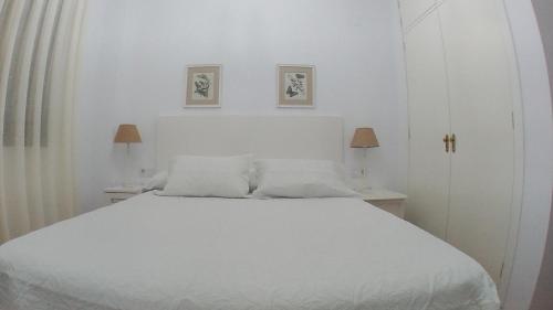 Säng eller sängar i ett rum på Apartamentos Vacacionales Atlanterra
