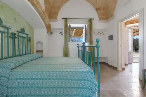 a bedroom with a green bed in a room at Villa Miliceddu in Tricase