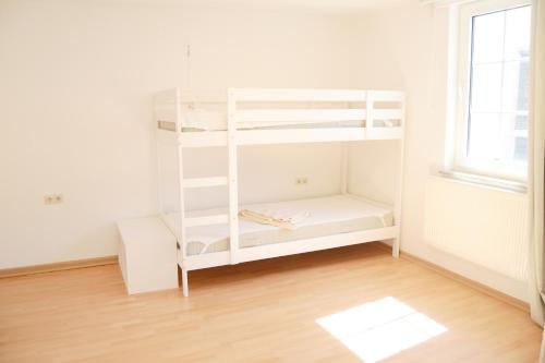 a white book shelf in a room with a window at #Hoenepartment - TimeOut Waldhessen - bis zu 8 Pers. in Hönebach
