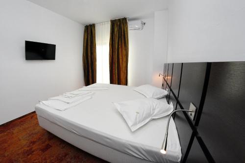 Krevet ili kreveti u jedinici u okviru objekta Hotel Mercur