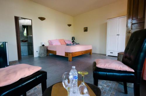 a bedroom with a bed and a table and chairs at Punta Duarte Garden Inn in Los Duarte