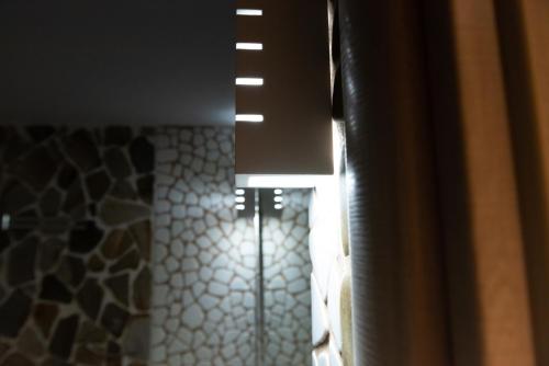 a light hanging from a window in a room at Evdokia's Apartments and Rooms in Neos Marmaras
