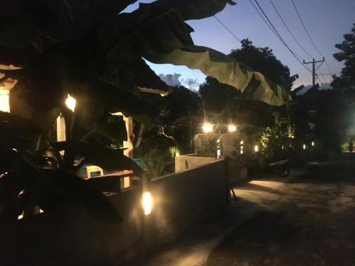 a group of soldiers jumping over a wall at night at Le Biu garden View in Nusa Lembongan