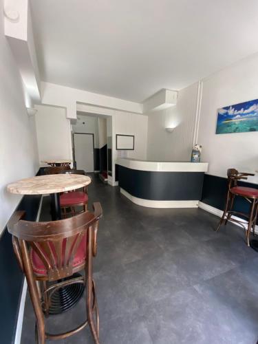 an empty room with a table and chairs at Hotel du Centre Lucé Chartres in Luce