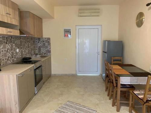 a kitchen with a table and a dining room at Toula's Apartments in Faliraki