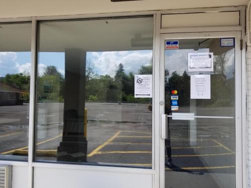 a glass door of a building with signs on it at Motel 6 Morgantown in Morgantown