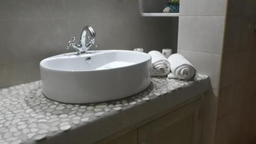 a white sink on a counter in a bathroom at Lampi's House in Patmos