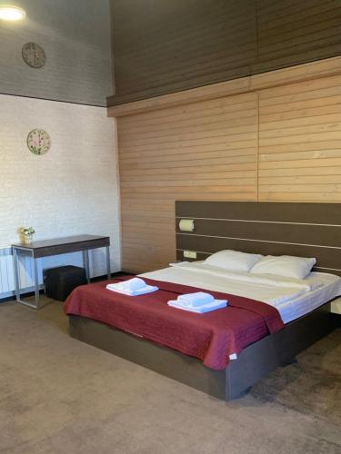 a bedroom with a bed with two towels on it at motel-Yasniy in Dnipro