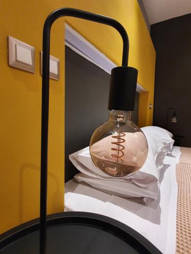 a glass lamp on top of a bed at Hotel Aphroditi Island Park in Alexandroupoli