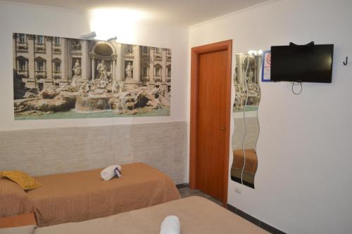 a room with two beds and a flat screen tv at A&F Colosseo in Rome