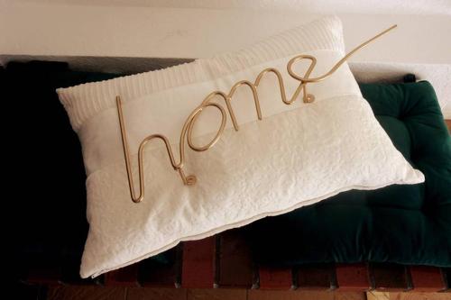 a white pillow with the word mom written on it at Appartement VILLA PAULA Ax-les-Thermes in Ax-les-Thermes