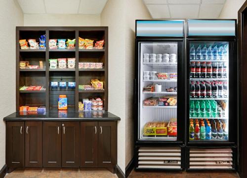 a store with an open refrigerator with drinks at La Quinta by Wyndham Denton - University Drive in Denton