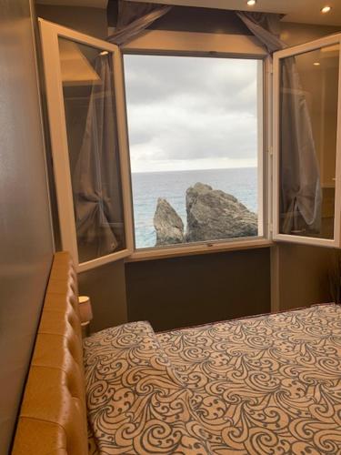 sypialnia z oknem z widokiem na ocean w obiekcie La Scogliera w mieście Monterosso al Mare