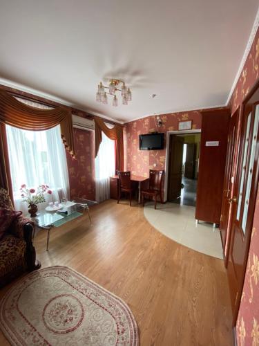a living room with a couch and a table at Золотий Лев in Zvenyhorodka