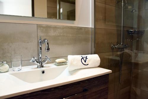 a bathroom sink with a towel on it at Le Charles V in Meursault