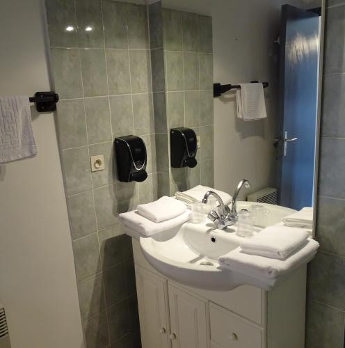a bathroom with a white sink and a shower at Hôtel Mas de l'Espaïre in Les Vans