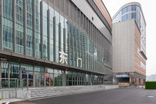 a large glass building with a street in front of it at Foshan Laide Apartment in Shunde