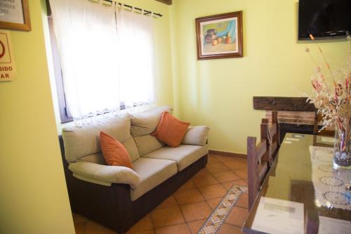 a living room with a couch and a table at Casas Rurales El Caminante in Aldeanueva del Camino