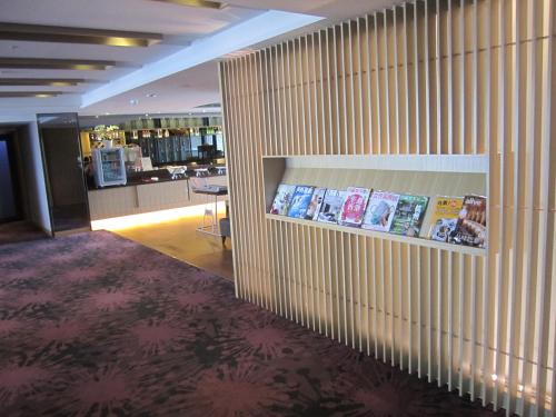 a lobby with a wall with books on it at Fullon Hotel Kaohsiung in Kaohsiung