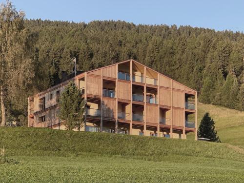 a large building on top of a hill at Gailerhof Hotel B&B Superior in Monguelfo