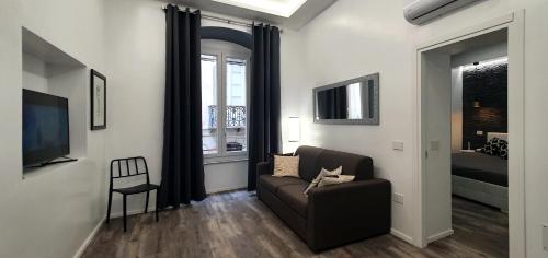 a living room with a couch and a television at Space Suite in Cagliari