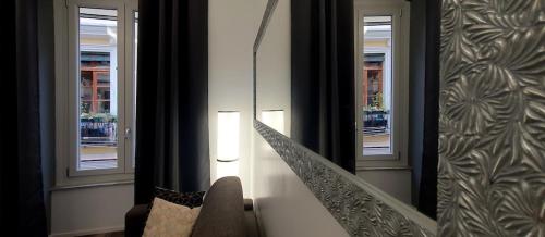a room with a staircase with windows and a chair at Space Suite in Cagliari