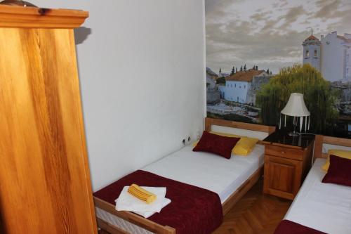 a bedroom with two beds and a view of a city at Hotel San in Trebinje