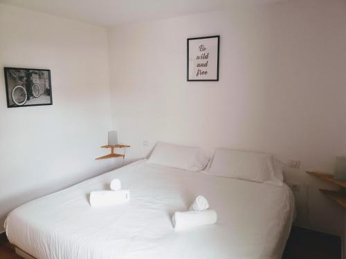 a white bed with two white towels on it at VV Duplex Isla Bonita "by henrypole home" in Los Cancajos
