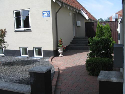 a house with a brick driveway in front of it at Odense Apartments in Odense