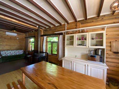 a kitchen and living room with a wooden ceiling at Fairy Tale in Gabala