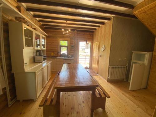 a kitchen with a wooden table in a room at Fairy Tale in Gabala