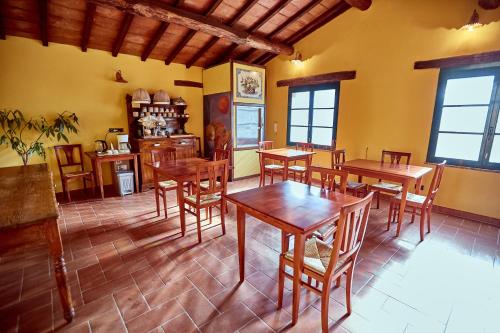 a dining room with wooden tables and chairs at Az.Agr. Il Cavalleggero in Campiglia dʼOrcia