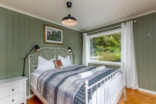 a bedroom with a bed and a window at Two bedroom apartment in beautiful Flåm valley in Flåm