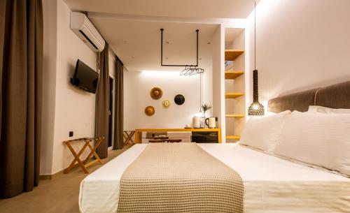 a bedroom with a large white bed in a room at Eleana Hotel in Tinos Town