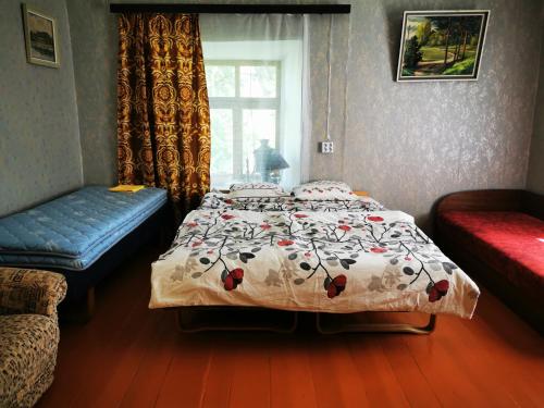 a bedroom with a bed and a window at Pilkalnes muiža in Nereta