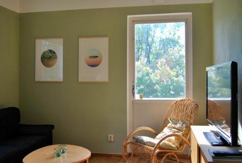 a living room with a table and a window at Hemmet B&B in Simrishamn