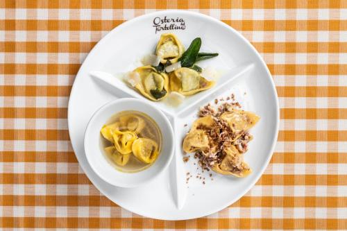 a plate of food with dumplings on a table at Hotel Mirandola in Mirandola