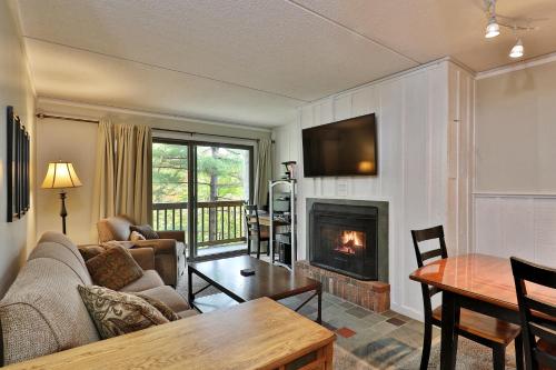 a living room with a couch and a fireplace at Cozy three bedroom condo, Ski home Whiffletree I3 in Killington