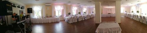 a room with rows of tables and chairs in a building at Willa Wiktoria in Międzylesie