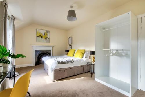 a bedroom with a bed and a fireplace at Oaktree Appartment Moffat in Moffat