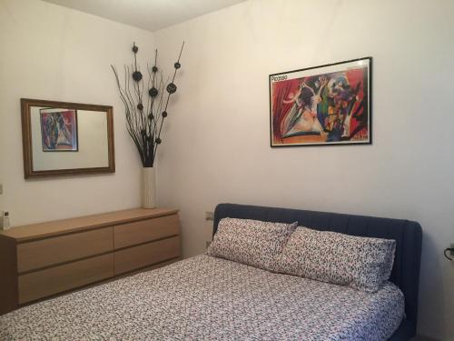 a bedroom with a bed and a painting on the wall at Il ponticello in Ortona