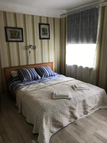 a bedroom with a bed with two towels on it at Family house Jurmala in Jūrmala