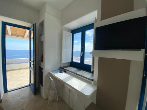 a room with a large window with a view of the beach at 'A Alera Room & Breakfast in Malfa