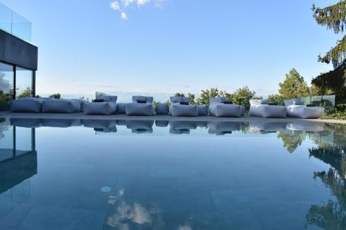 a swimming pool with a couch and some water at Hotel Urbisol in Calders