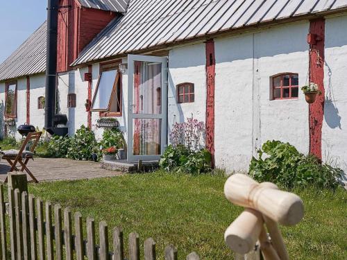 een huis met een hek ervoor bij 6 person holiday home in Nex in Neksø